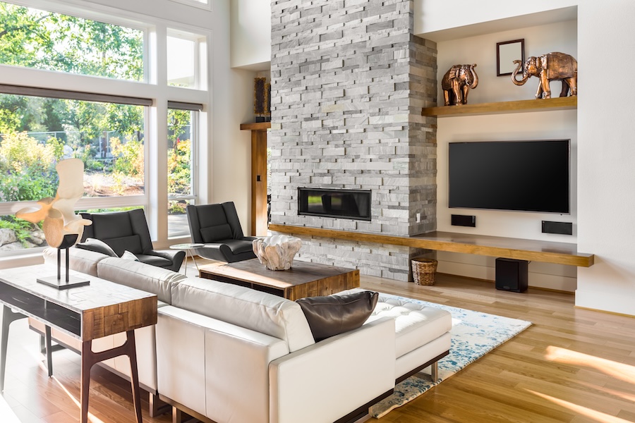 TV and speakers installed under a shelf in a living room.